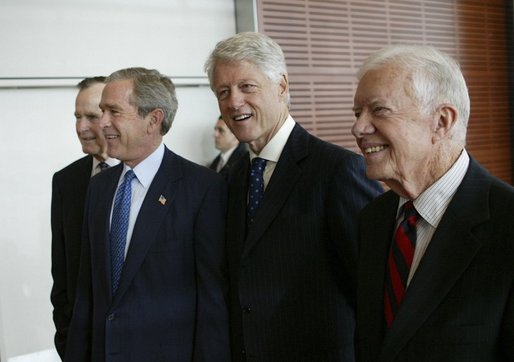 President George W. Bush, walks with, from left, former President George H.W. Bush, former President Bill Clinton, and former President Jimmy Carter during the dedication of the William J. Clinton Presidential Center and Park in Little Rock, Ark., Nov. 18, 2004. White House photo by Eric Draper.