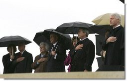 President George W. Bush and Laura Bush stand at attention with, from left, former President Jimmy Carter and First Lady Rosalynn Carter; former President George H.W. Bush and First Lady Barbara Bush; and former President Bill Clinton, Chelsea Clinton, and Sen. Hillary Clinton (not pictured) during the dedication ceremony of the William J. Clinton Presidential Center and Park in Little Rock, Ark., Nov. 18, 2004.  White House photo by Eric Draper