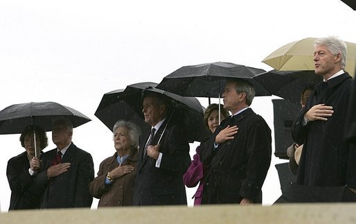President George W. Bush and Laura Bush stand at attention with, from left, former President Jimmy Carter and First Lady Rosalynn Carter; former President George H.W. Bush and First Lady Barbara Bush; and former President Bill Clinton, Chelsea Clinton, and Sen. Hillary Clinton (not pictured) during the dedication ceremony of the William J. Clinton Presidential Center and Park in Little Rock, Ark., Nov. 18, 2004. White House photo by Eric Draper.