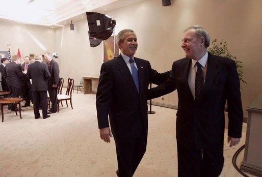 President George W. Bush and Canadian Prime Minister Paul Martin share a light moment after a bilateral meeting in Santiago, Chile, Nov. 20, 2004. President Bush and Prime Minister Martin are joined in Chile by the leaders of 19 other countries attending this year's APEC summit. White House photo by Eric Draper
