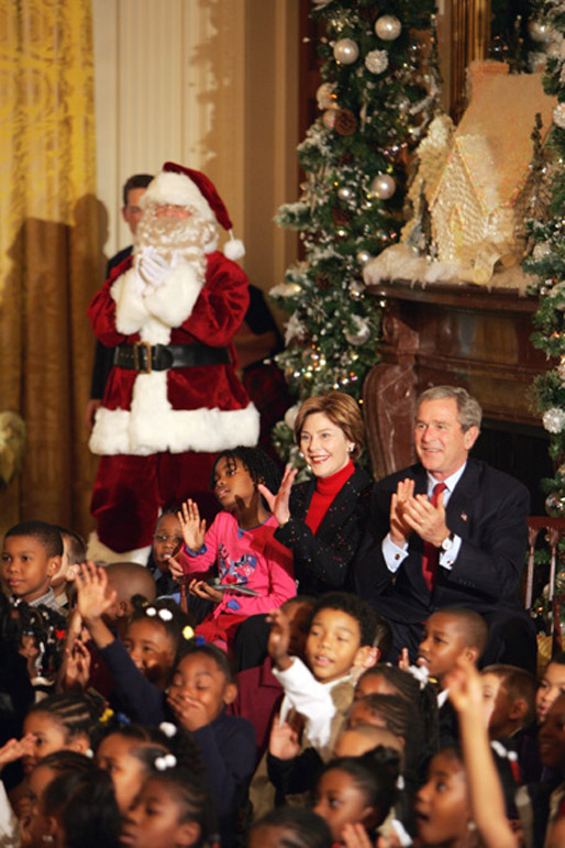 President George W. Bush Laura Bush watch a puppet show and sing Christmas Carols with dozens of school children attending the White House Children's Christmas Program in the East Room, Monday, Dec. 6, 2004. White House photo by Susan Sterner