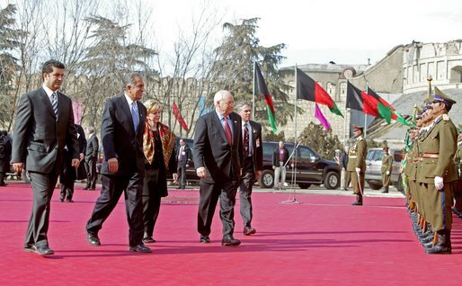 Prior to the inauguration of Afghanistan President Hamid Karzai, Vice President Dick Cheney and his wife, Lynne, and U.S. Ambassador to Afghanistan Zalmay Khalilzad, second on left, attend a welcoming ceremony at the Presidential Palace in Kabul, Afghanistan, Dec. 7, 2004. White House photo by David Bohrer