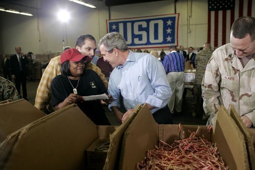 President George W. Bush and Laura Bush visit Operation USO CarePackage at Fort Belvior, Va., Friday, Dec. 10, 2004. "This is one way of saying, America appreciates your service to freedom and peace and our security," said the President in his remarks about the program that has delivered more than 480,000 care packages.White House photo by Paul Morse
