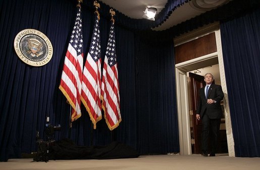 President George W. Bush arrives at a press conference in room 450 of the Eisenhower Executive Office Building on December 20, 2004. White House photo by Paul Morse.