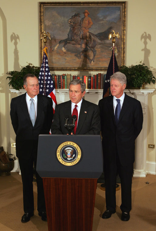 President George W. Bush announces a nationwide charitable fundraising effort to be led by former President George H.W. Bush, left, and former President Bill Clinton to aid victims of last week's earthquake and tsunamis in South Asia in the Roosevelt Room, Monday, January 3, 2005. White House photo by Tina Hager.