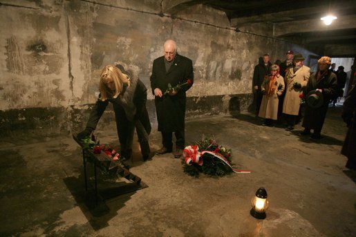 Vice President Dick Cheney and his daughter Liz Cheney, left, along with other members of a U.S. delegation, lay flowers at a memorial inside the first gas chamber at the Auschwitz-1 Nazi concentration camp, near Krakow, Poland, Jan. 28, 2005. Vice President Cheney was there to take part in ceremonies commemorating the 60th Anniversary of the liberation of the Auschwitz camps. The Wall of Death was named for its use as the backdrop for firing squads where thousands of prisoners were executed while the camp was in operation. White House photo by David Bohrer