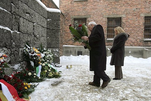 Vice President Dick Cheney, flanked by his daughter Liz Cheney, places a bouquet of flowers at the Wall of Death at the Auschwitz-1 Nazi concentration camp, near Krakow, Poland, Friday, Jan. 28, 2005. Vice President Cheney was there to take part in ceremonies commemorating the 60th Anniversary of the liberation of the Auschwitz camps. The Wall of Death was named for its use as the backdrop for firing squads where thousands of prisoners were executed while the camp was in operation. White House photo by David Bohrer