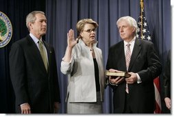 With President George W. Bush and her husband Robert Spellings by her side, Secretary of Education Margaret Spellings takes the oath of office during a ceremony at the Department of Education in Washington, D.C., Monday, Jan. 31, 2005. Secretary Spellings served as an Assistant to the President for Domestic Policy during the first term of the Bush administration.  White House photo by Paul Morse