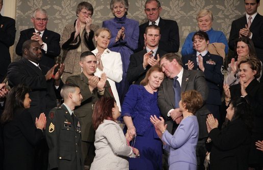 During the State of the Union Address Wednesday, Feb. 2, 2005, Janet and William Norwood, center, comfort each other as President Bush talks about their son, Marine Corps Sergeant Byron Norwood of Pflugerville, Texas, who died during the assault on Fallujah. "Ladies and gentlemen, with grateful hearts, we honor freedom's defenders, and our military families, represented here this evening by Sergeant Norwood's mom and dad, Janet and Bill Norwood," President Bush said during his speech at the U.S. Capitol. White House photo by Eric Draper
