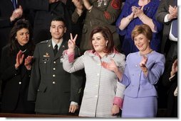 Safia Taleb al-Suhail, leader of the Iraqi Women's Political Council, second on right, displays a peace sign as other guests applaud during President George W. Bush's State of the Union speech at the U.S. Capitol, Wednesday, Feb. 2, 2005. Also pictured are, from left, Kindergarten teacher Lorna Clark of Santa Theresa, New Mexico, Army Staff Sergeant Norbert Lara, and Laura Bush.   White House photo by Paul Morse