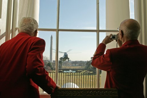 Members of the famed Tuskegee Airmen watch as President Bush returns to the White House aboard Marine One Tuesday, Feb. 8, 2005. The Airmen were at the White House to attend a ceremony honoring February as African American History Month. White House photo by Susan Sterner