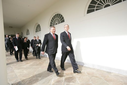 President George W. Bush and Aleksander Kwasniewski, the President of Poland, walk along the colonnade to the Oval Office Wednesday, Feb. 9, 2005. White House photo by Eric Draper