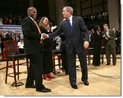 President George W. Bush greets his fellow stage participants during a Town Hall meeting on strengthening Social Security in Raleigh, N.C., Thursday, Feb. 10, 2005.  White House photo by Eric Draper