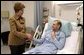 Laura Bush visits with U.S. Army Specialist Garrett Larson who is recovering from injuries sustained in Iraq at the Landstuhl Regional Medical Center Tuesday, Feb. 22, 2005, in Ramstein, Germany. White House photo by Susan Sterner