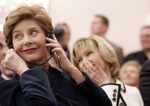 Laura Bush listens to translation headphones during a joint press conference with President George W. Bush and German Chancellor Gerhard Schroeder at the Electoral Palace in Mainz, Germany, Wednesday, Feb. 23, 2005. The Chancellor’s wife, Mrs. Schroeder-Koepf is seated next to Mrs. Bush. White House photo by Eric Draper