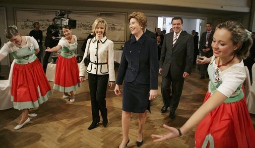 Laura Bush watches dancers during a Wednesday, Feb. 23, 2005, lunch hosted by Chancellor Gerhard Schroeder, behind, and Mrs. Schroeder-Koepf, left, at the Electoral Palace in Mainz, Germany. White House photo by Eric Draper
