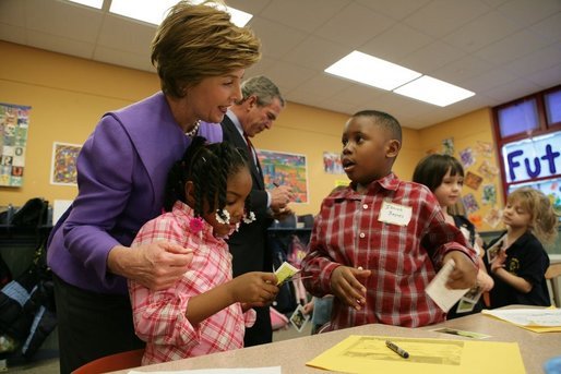 Laura Bush talks with Providence Family Support Center after-school program participants Isaiah Baynes, right, and Carlaija Whitehead during her visit and President Bush's to Pittsburgh to highlight the program's efforts to help area youth Monday, March 7, 2005. White House photo by Susan Sterner