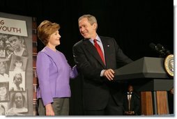 President George W. Bush and Laura Bush laugh as he introduces her during her remarks on Helping America's Youth at the Community College of Allegheny County in Pittsburgh Monday, March 7, 2005.  White House photo by Susan Sterner