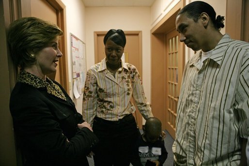 Laura Bush speaks with Kenyatta "Ken" Thigpen, his girlfriend Jewell Reed and their three-year-old son, Kevion, during a visit to the Rosalie Manor Community and Family Services center in Milwaukee, Wis., Tuesday, March 8, 2005. Mrs. Bush credits a New York Times article by Jason DeParle about Mr. Thigpen's determination to be a responsible father with bringing her attention to the needs of boys and young men. White House photo by Susan Sterner