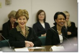 Laura Bush and Secretary of State Condoleezza Rice laugh during a roundtable discussion with women leaders from around the world held in honor of International Women's Day at the State Department in Washington, D.C. Tuesday, March 8, 2005. Today in her remarks at the State Department Mrs. Bush said, "We all have an obligation to speak for women who are denied their rights to learn, to vote or to live in freedom. We may come from different backgrounds, but advancing human rights is the responsibility of all humanity, a commitment shared by people of goodwill on every continent."  White House photo by Susan Sterner