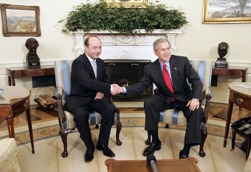President George W. Bush welcomes Romanian President Traian Basescu to the Oval Office Wednesday, March 9, 2005. President Bush and President Basescu met to discuss regional security and diplomatic issues. White House photo by Paul Morse