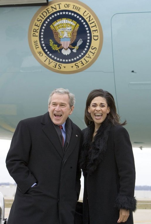 President George W. Bush laughs with USA Freedom Corps greeter Monica Hardin in front of Air Force One in Louisville, Ky., Thursday, March 10, 2005. White House photo by Paul Morse