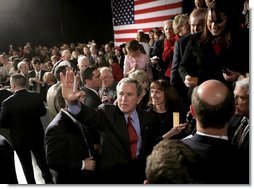 President George W. Bush waves to the crowd at the end of his ‘Conversation on Strengthening Social Security’ Monday, March 21, 2005, in Denver. The President took his plans for reform to an estimated 1,200 guests at the Wings Over the Rockies Air and Space Museum.  White House photo by Eric Draper