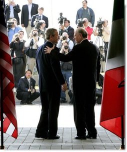 President George W. Bush greets Canadian Prime Minister Paul Martin at the beginning of meetings between the United States, Mexico and Canada at Baylor University in Waco, Texas, Wednesday, March 23, 2005.   White House photo by Eric Draper