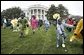 Children slip through a race with their Easter eggs during the traditional race on the South Lawn. Although rainy weather cut short the event, children and their parents made many colorful memories to brighten up a gray, gloomy day. White House photo by Paul Morse