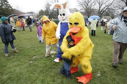 Cold days bring warm hugs as the Easter Bunny and his friends greets young visitors to a soggy South Lawn the 2005 White House Easter Egg Roll. White House photo by Paul Morse