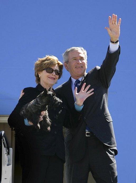 Mrs. Bush holds onto Miss Beazley Monday, March 28, 2005, as she and President George W. Bush wave goodbye upon boarding Air Force One in Waco, Texas, en route home to Washington D.C. White House photo by Eric Draper