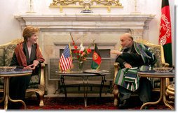 Afghan President Hamid Karzai jokes with Laura Bush during a meeting in the Presidential Palace in Kabul, Afghanistan, Wednesday, March 30, 2005.