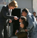 Laura Bush is greeted by youngsters outside a Kabul bakery during her visit Wednesday, March 30, 2005. The first lady presented White House red, white & blue kaleidoscopes to the children. White House photo by Susan Sterner