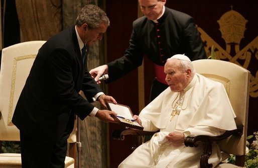The President presents the Medal of Freedom to Pope John Paul II during a visit to the Vatican in Rome, Italy in June 2004. White House photo by Eric Draper