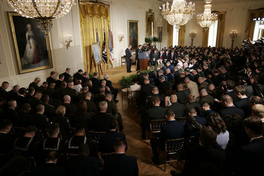 The audience bows its head as Major General David Hicks, standing at the podium, gives the invocation Monday, April 4, 2005, during the posthumous Medal of Honor ceremony for Sgt. 1st Class Paul Smith at the White House.White House photo by Paul Morse