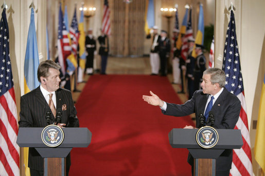 President George W. Bush gestures to Ukraine President Viktor Yushchenko Monday, April 4, 2005, during a press availability at the White House.White House photo by Paul Morse