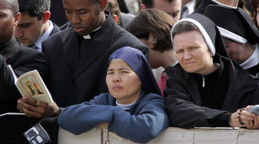 Faces of some of those in attendance Friday, April 8, 2005 inside St. Peter's Square for funeral services for Pope John Paul II.White House photo by Eric Draper