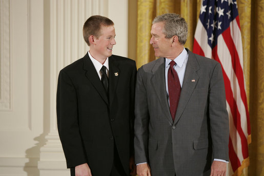 President George W. Bush congratulates Scott Elder, 15, of Chino Hills High School in Chino Hills, Calif., on receiving the President’s Environmental Youth Award in the East Room of the White House April 21, 2005. White House photo by Paul Morse