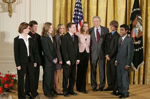 President George W. Bush congratulates members of the Cairo High School Science Club and Biology Students’ Environmental Issues Outreach Program in Cairo, Ga., on receiving the President’s Environmental Youth Award in the East Room of the White House April 21, 2005. Members of this club include, from left, Anna Dorsey, 16, Luke Walden, 16, Brian Dekle, 19, Jessica Brock, 19, John Palmer, 16, Keri Cassels, 16, Brandon Phillips, 19, and Vikram Jambulapati, 18. White House photo by Paul Morse