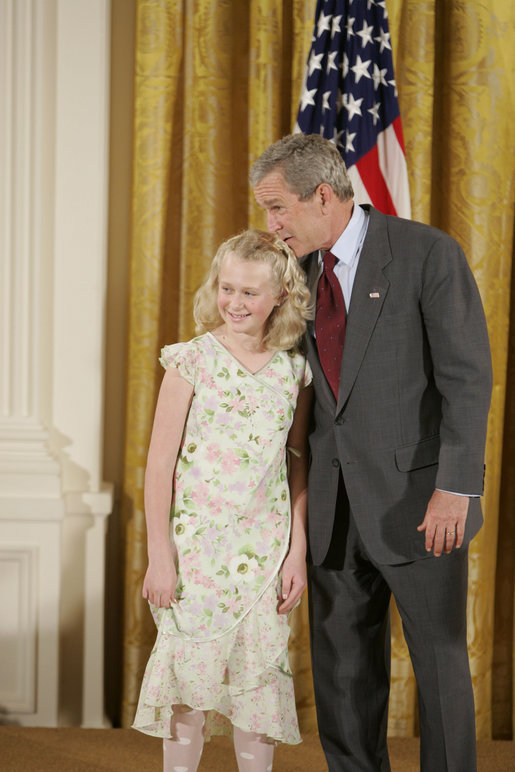 President George W. Bush congratulates Allyson Lien, 11, of Humann Elementary School in Lincoln, Neb., on receiving the President’s Environmental Youth Award in the East Room of the White House April 21, 2005. White House photo by Paul Morse
