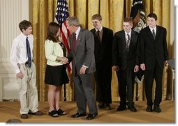 President George W. Bush congratulates students of South Cache 8th and 9th Grade Center in Hyrum, Utah, on receiving the President’s Environmental Youth Award in the East Room of the White House April 21, 2005. Members include, from left to right, Parker Hellstern, 14, Tana Hellstern, 16, Aaron Lusk, 15, Bryan Miller, 14, and Jason Newhall, 14. White House photo by Paul Morse