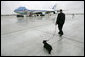 Presidential Valet Master Chief Sam Sutton escorts Barney to Air Force One prior to the President’s arrival at Andrews Air Force Base, Friday, April 22, 2005. The President will spend the weekend at his Texas ranch in Crawford after a stop in Tennessee. White House photo by Eric Draper