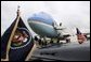 President George W. Bush waves goodbye while boarding Air Force One before departing McGhee Tyson Air National Guard Base in Knoxville en route to his ranch in Crawford, Texas, Friday, April 22, 2005. White House photo by Eric Draper