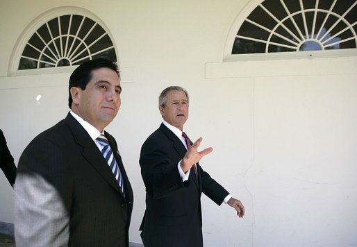 President George W. Bush and Panamanian President Martin Torrijos walk along the colonnade in the Rose Garden during his visit Thursday, April 28, 2005. White House photo by Eric Draper