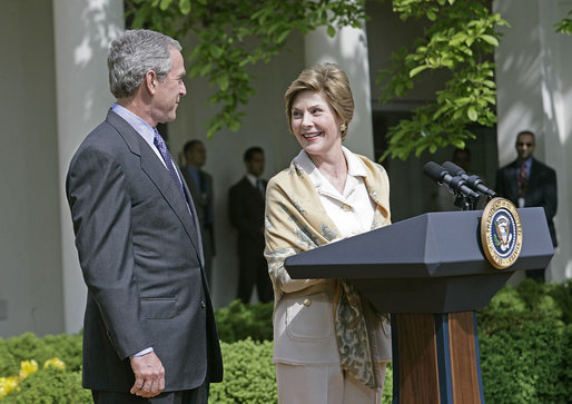 Laura Bush looks over to President Bush during a Rose Garden announcement honoring the 2005 Preserve America Presidential Awards Winners Monday, May 2, 2005. "These awards recognize collaborative efforts to protect and enhance our nation's cultural and historical heritage," said Mrs. Bush in her remarks.White House photo by Eric Draper