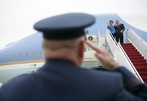 President George W. Bush returns a salute from Brigadier General David S. Gray, Commander, 89th Airlift Wing as he and Mrs Bush board Air Force One before departing Andrews Air Force Base for Latvia, Friday, May 6, 2005. White House photo by Eric Draper