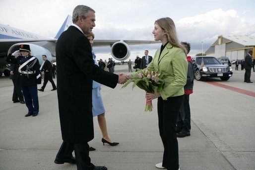 President George W. Bush and Laura Bush are presented with tulips upon their arrival in Maastricht, Netherlands, May 7, 2005. White House photo by Eric Draper