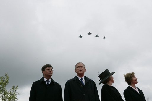 Jan Peter Balkenende, Prime Minister of The Netherlands, left, President George W. Bush, Queen Beatrix of The Netherlands, and Mrs. Laura Bush stand on stage Sunday, May 8, 2005, at the Netherlands American Cemetery in Margraten, as a flyover marks the remembrance of those who served in World War II. White House photo by Eric Draper