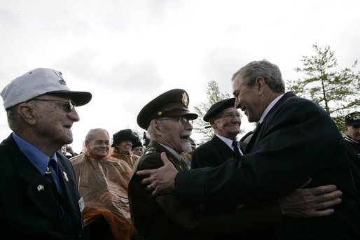 President George W. Bush greets veterans at the Netherlands American Cemetery in Margraten Sunday, May 8, 2005, following a ceremony honoring those who served in World War II. White House photo by Eric Draper