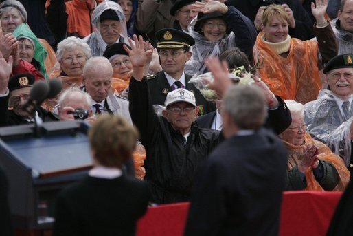 President George W. Bush and Mrs. Bush wave to a crowd at the American Cemetery in Margraten, Netherlands Sunday, May 8, 2005, honoring those who served in World War II 60 years ago. White House photo by Paul Morse